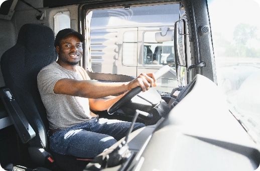 professional-african-american-truck-driver-casual-clothes-driving-truck-vehicle-going-long-transportation-route@2x Professional african american truck driver casual clothes driving truck vehicle going long transportation route@2x