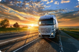 white-semi-truck-driving-road-sunset White semi truck driving road sunset